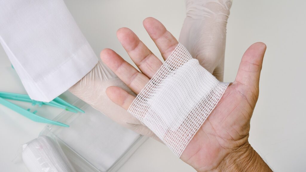 Doctor,Doing,Wound,Dressing,Care,And,Bandaging,Patient's,Hand,,Hand
